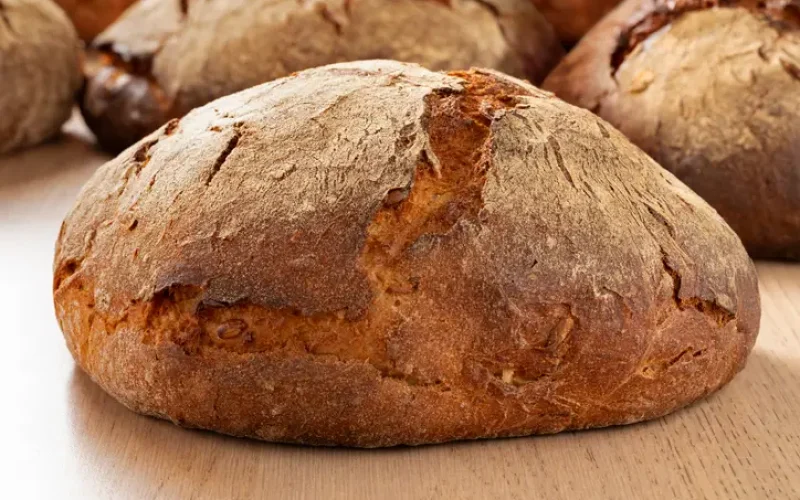 Traditional German sourdough loaf of bread in the bakery close up Traditional German sourdough loaf of bread with a crunchy crust in the bakery close up